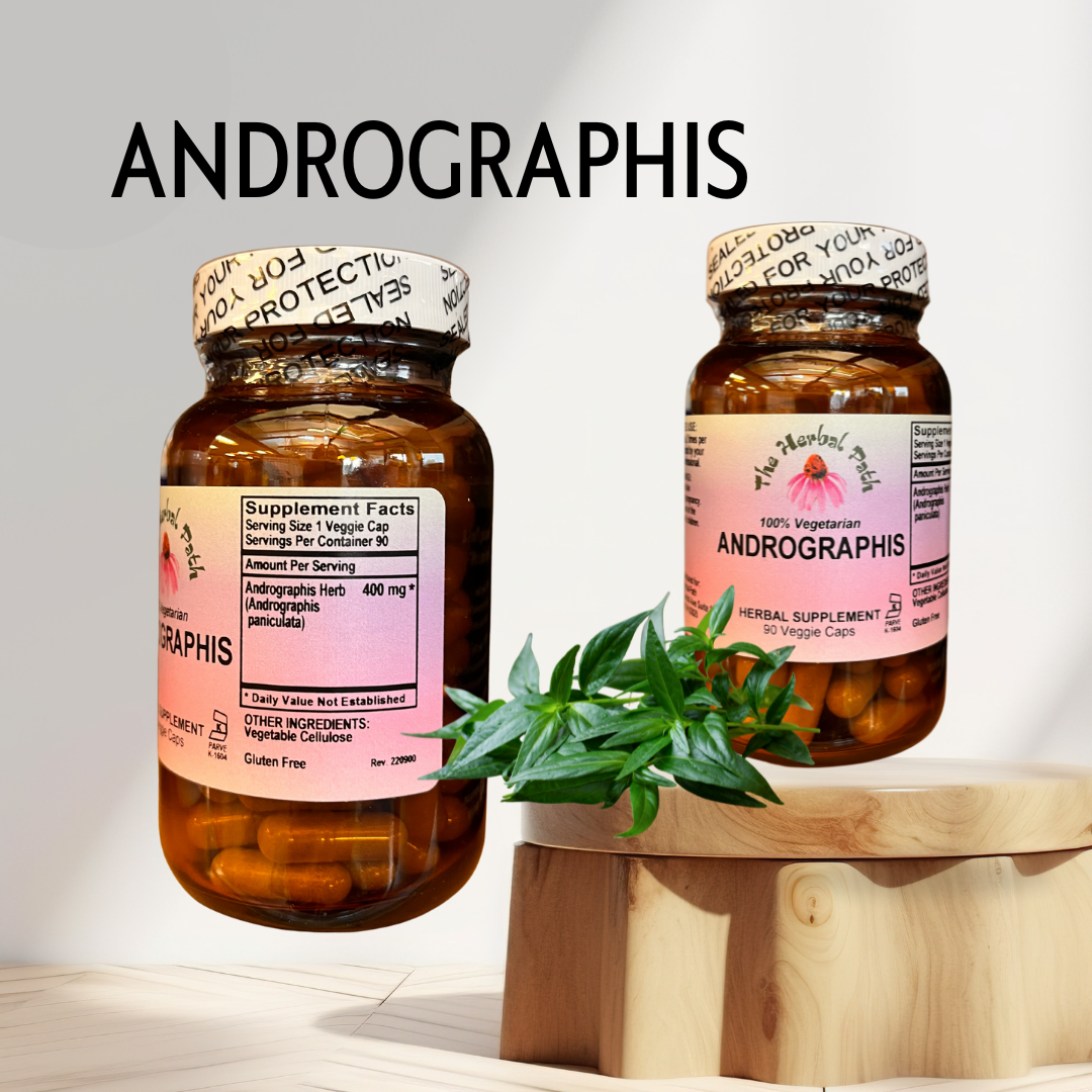 Two bottles of Andrographis supplement on a wooden stand with a plant leaf.