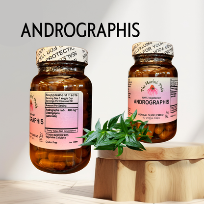 Two bottles of Andrographis supplement on a wooden stand with a plant leaf.