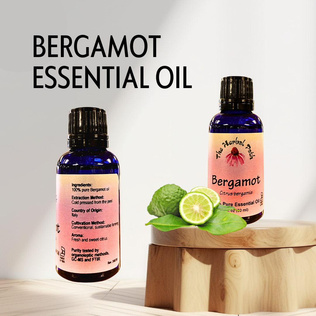 Two bottles of Bergamot Essential Oil with a lime and leaves on a wooden stand against a light background.
