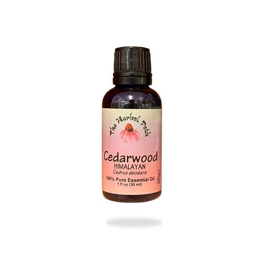 Bottle of Cedarwood Himalayan essential oil with pink The Herbal Path label.