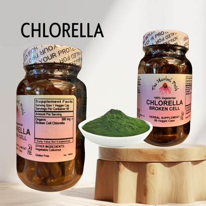 Two bottles of chlorella supplement with a bowl of green powder on a wooden stand.