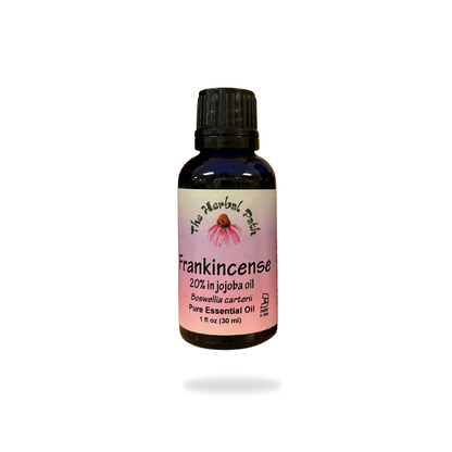 Bottle of Frankincense essential oil with a pink The Herbal Path label.