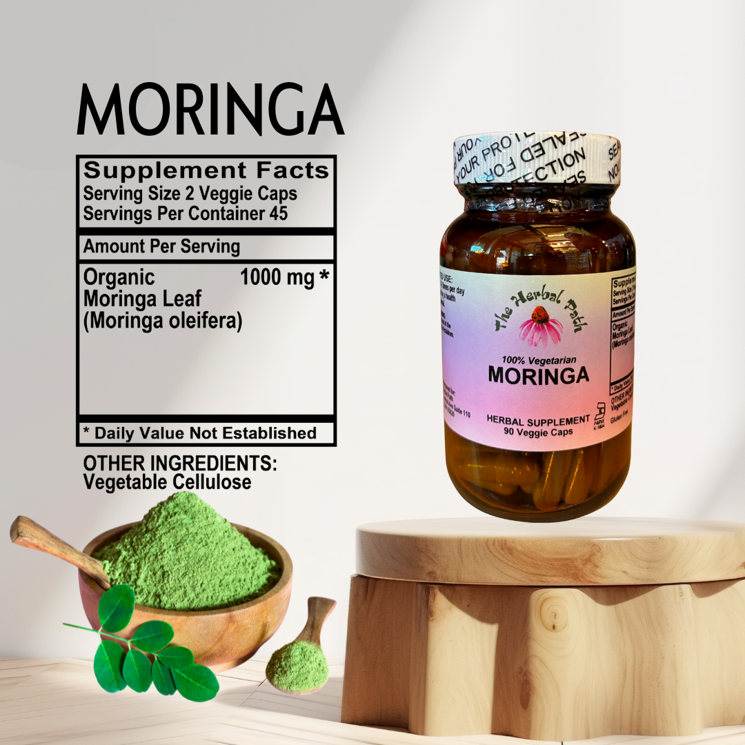 Moringa supplement bottle with green powder and leaves on a wooden surface