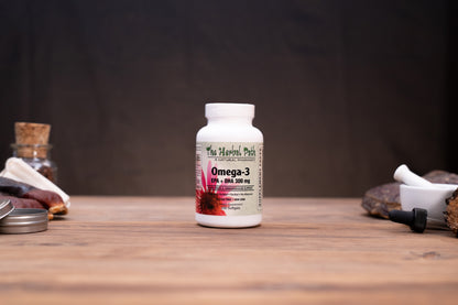 A white bottle of The Happy Peth Omega-3 DHA 200 mg supplement, set on a rustic wooden table with herbal props in the background.