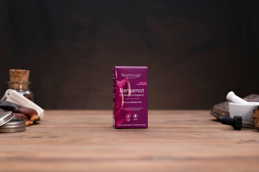 A box of Berberine Gummies by Resurgence on a wooden tabletop, flanked by apothecary props like a glass bottle and mortar and pestle against a dark background.