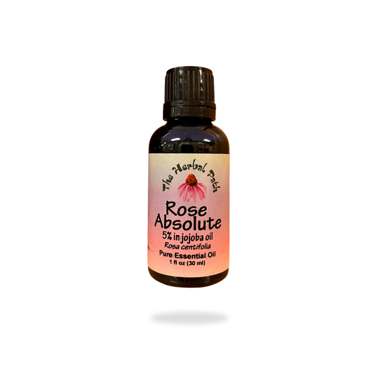 Bottle of Rose Absolute essential oil with a pink label on a white background