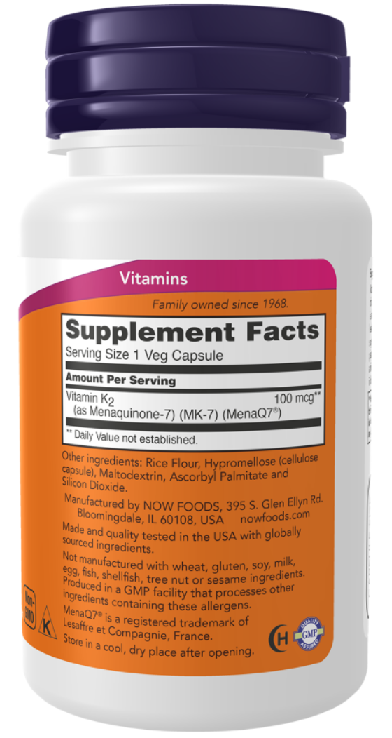 A white plastic bottle of NOW Foods Vitamins with a dark purple cap and an orange and white supplement facts label.