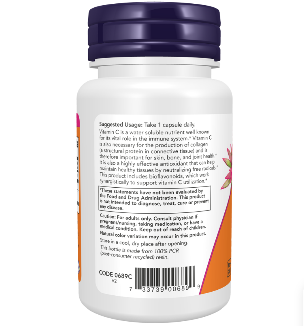 A white plastic bottle of Vitamin C capsules with a dark blue cap, showing the back label with usage, warnings, and a barcode on a light gray background.