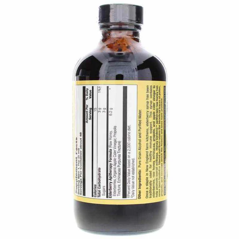 An amber glass bottle of vanilla extract with a black cap, showing the front nutrition label and ingredients list on a white background.