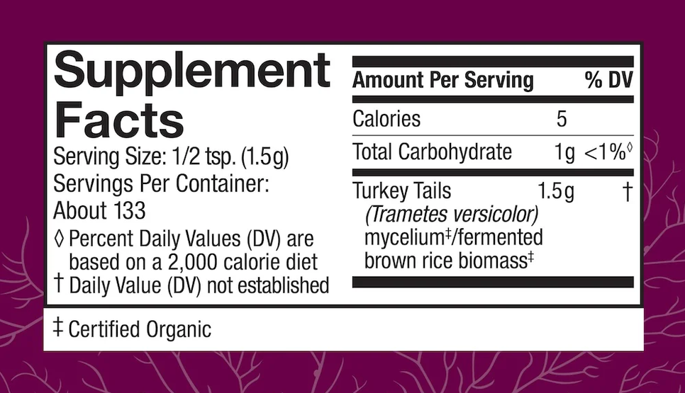 A close-up of a supplement facts label on a purple package background. The label is white with black text and shows serving size, calories, total carbohydrate, turkey tails, and certified organic information.